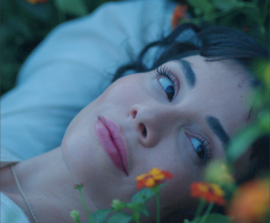 Woman resting in a bed of flowers